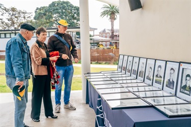 Guest viewing portraits of servicemen at Sandakan Remembrance Service 2024